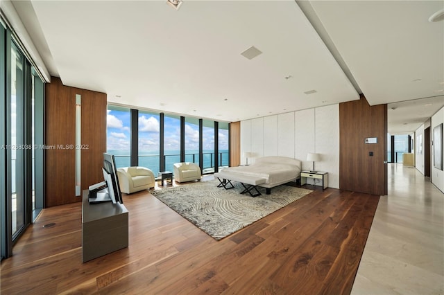 living room featuring a water view, hardwood / wood-style floors, and plenty of natural light