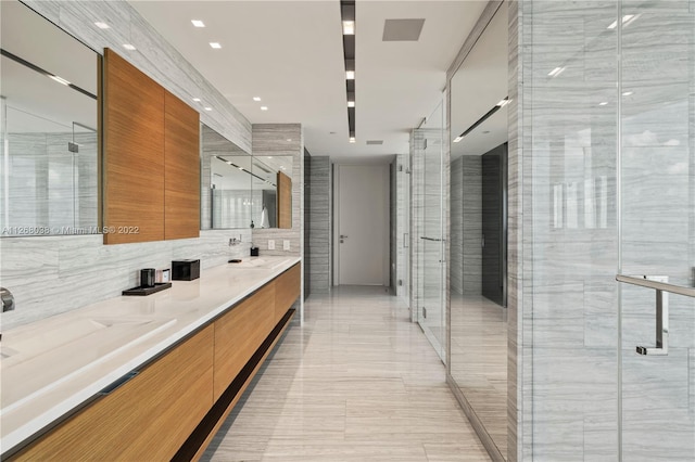 interior space featuring sink, tasteful backsplash, light tile flooring, and tile walls