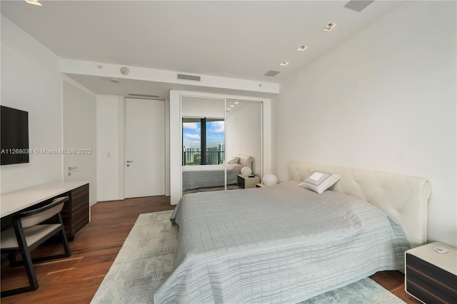 bedroom with dark wood-type flooring