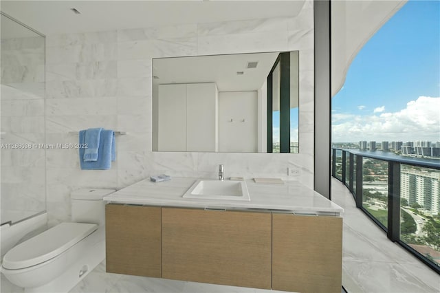 bathroom with toilet, vanity, tasteful backsplash, tile walls, and tile flooring