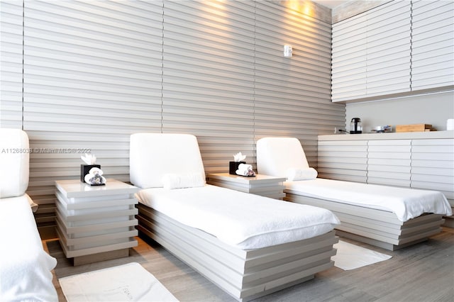 bedroom with a towering ceiling and light hardwood / wood-style flooring