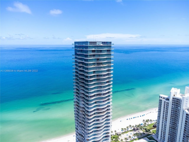 birds eye view of property featuring a beach view and a water view