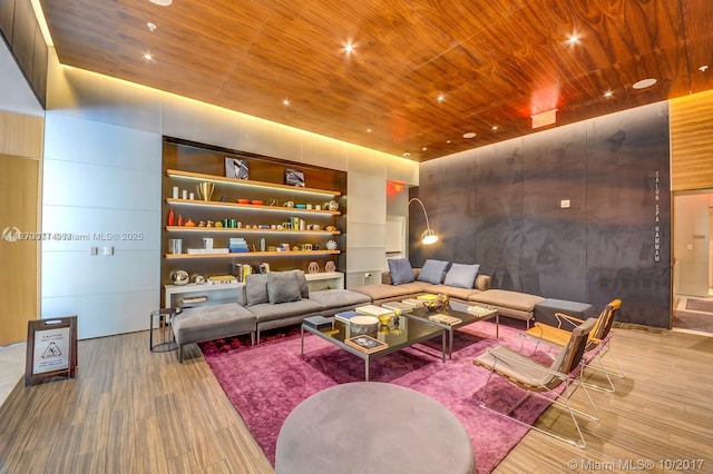living area with wooden ceiling, wood finished floors, recessed lighting, and built in shelves