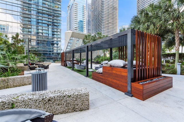 view of property's community with a patio area and a view of city