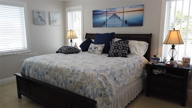 bedroom featuring tile flooring and multiple windows