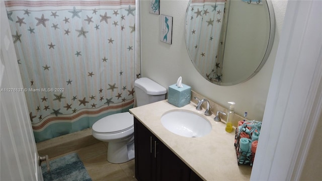 bathroom with toilet, tile floors, and vanity