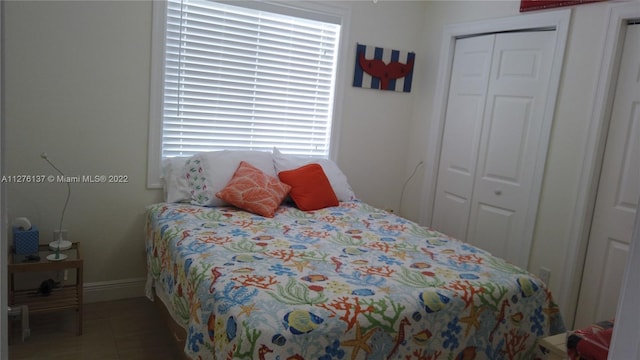 tiled bedroom with a closet