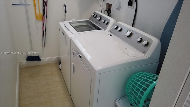 laundry area with washing machine and clothes dryer, washer hookup, and light tile floors