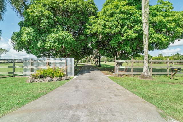 view of gate with a yard