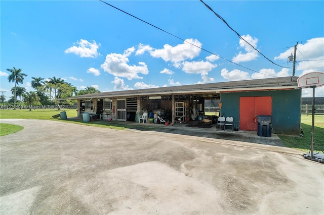 exterior space with a front lawn and a storage shed