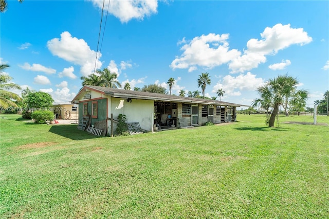 back of house with a lawn