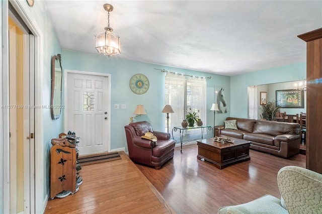 living room with a notable chandelier and wood-type flooring