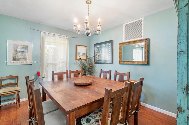 dining area with a chandelier and dark hardwood / wood-style floors