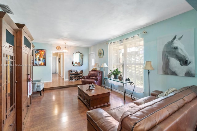 living room featuring a chandelier and hardwood / wood-style flooring