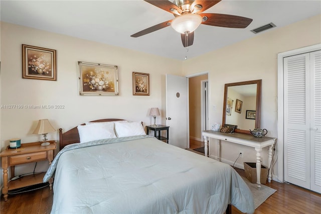 bedroom featuring a closet, ceiling fan, and dark hardwood / wood-style flooring