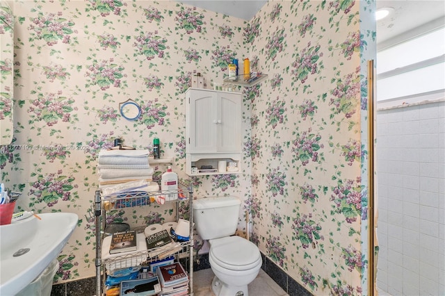 bathroom with sink, tile floors, and toilet