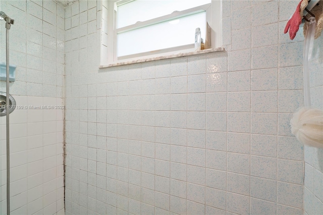 bathroom with tiled shower