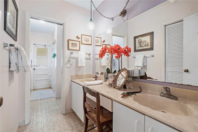 bathroom featuring tile flooring, large vanity, and dual sinks