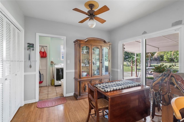 dining room with washer / clothes dryer, ceiling fan, and light wood-type flooring