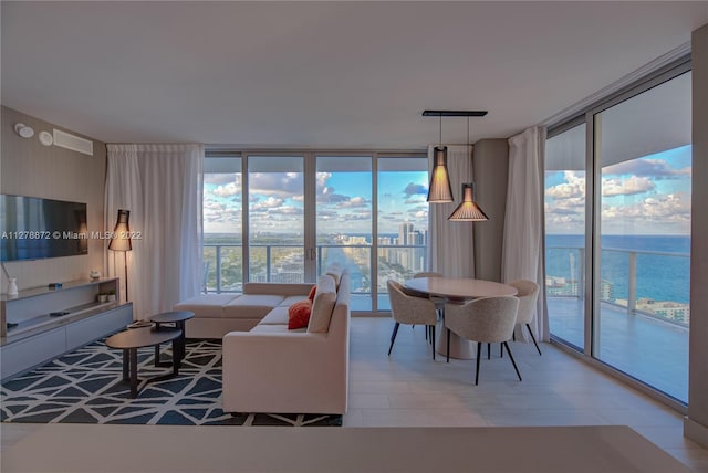 living room with light tile floors, a wall of windows, and a water view