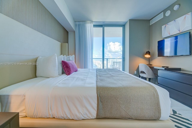 bedroom with light hardwood / wood-style flooring and access to outside