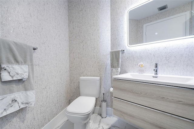 bathroom with tile floors, toilet, and vanity