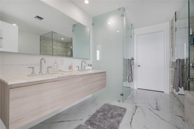 bathroom featuring double sink vanity, a shower with door, and tile flooring