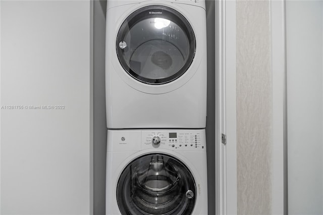 laundry room featuring stacked washer / drying machine