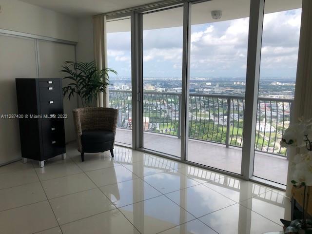 interior space with light tile flooring and expansive windows