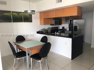 kitchen featuring appliances with stainless steel finishes and light tile floors