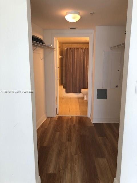 hallway with dark hardwood / wood-style floors