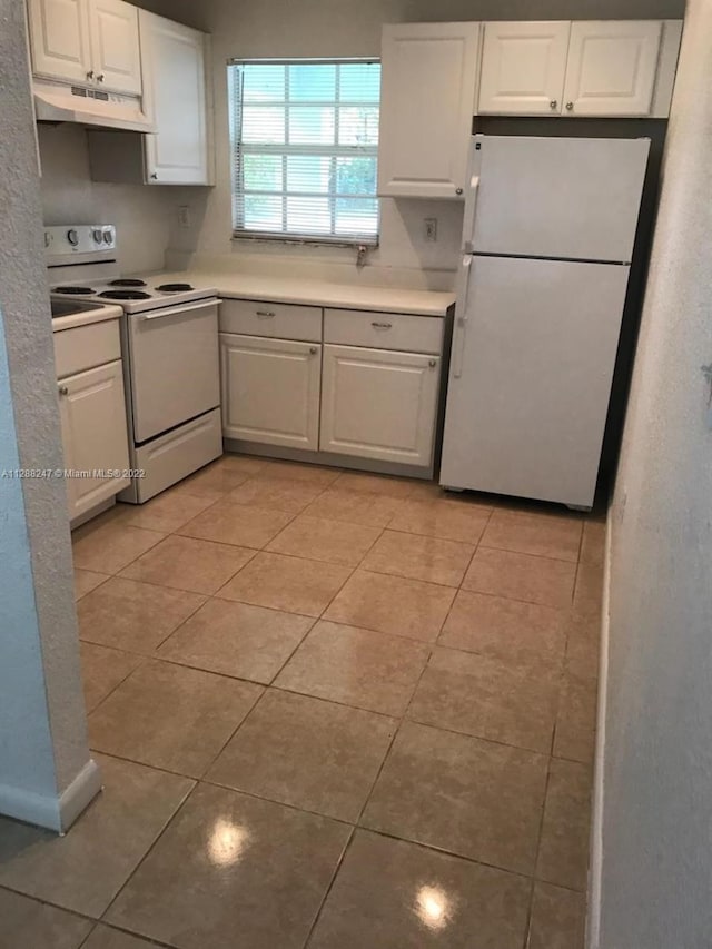 kitchen featuring white cabinetry and white appliances