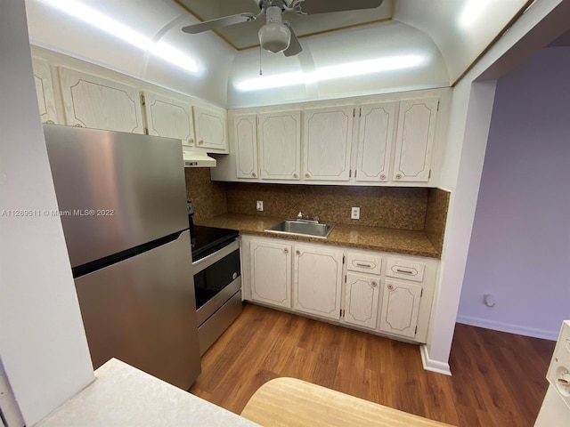 kitchen with ceiling fan, custom exhaust hood, light hardwood / wood-style flooring, stainless steel appliances, and tasteful backsplash