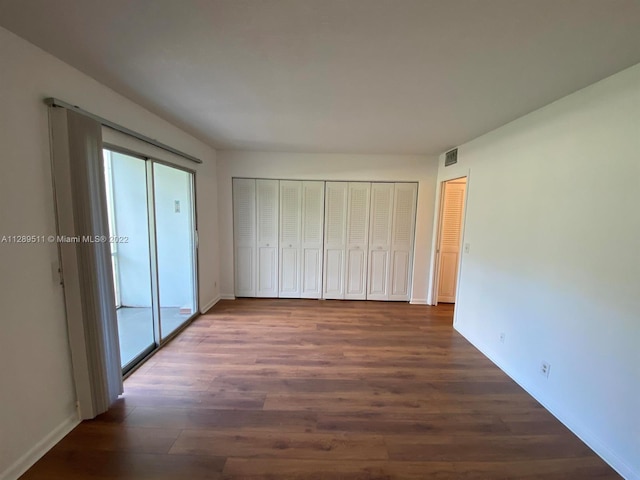 unfurnished bedroom featuring dark hardwood / wood-style flooring