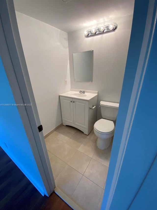 bathroom with vanity, tile flooring, and toilet