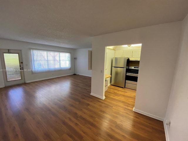 interior space with stove, white cabinetry, stainless steel refrigerator, and light hardwood / wood-style flooring