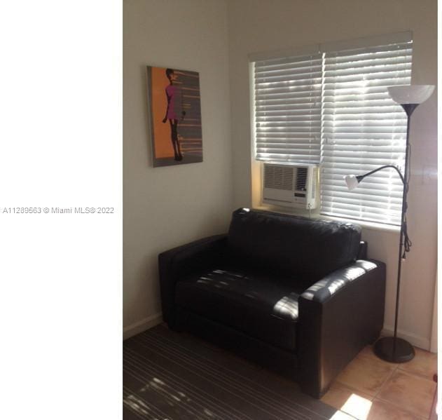 living area with a healthy amount of sunlight and dark tile floors