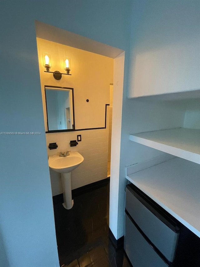 bathroom featuring tasteful backsplash and tile flooring