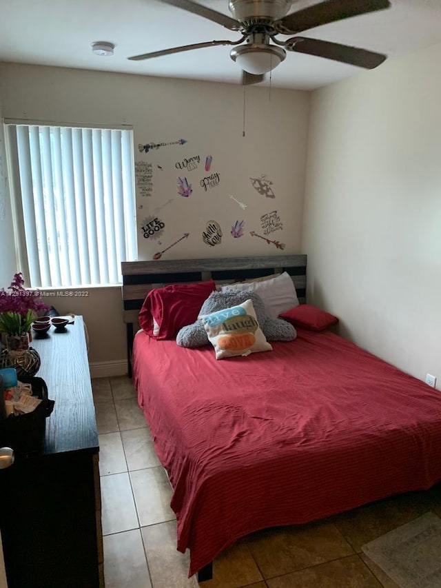 bedroom with light tile floors and ceiling fan