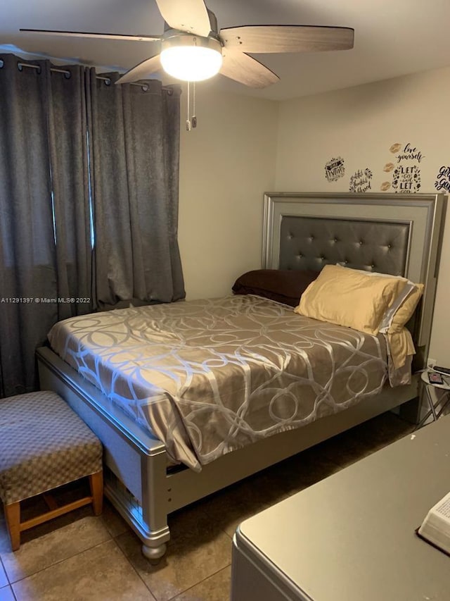 tiled bedroom with ceiling fan