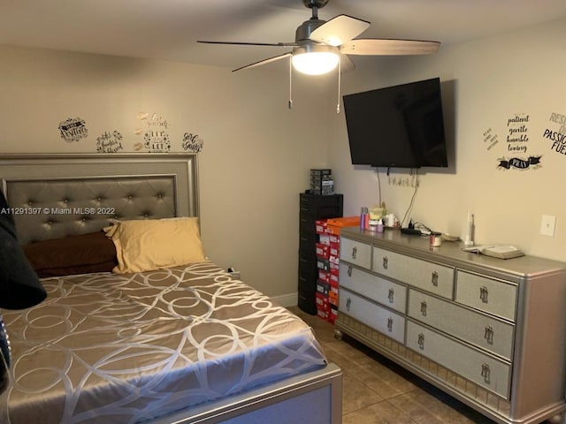 tiled bedroom featuring ceiling fan