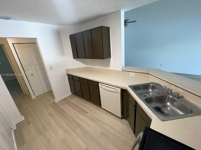 kitchen with sink, light hardwood / wood-style flooring, dishwasher, a textured ceiling, and dark brown cabinetry