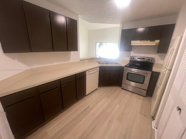 kitchen featuring white appliances, dark brown cabinetry, sink, and light wood-type flooring