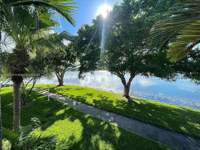 surrounding community featuring a yard and a water view