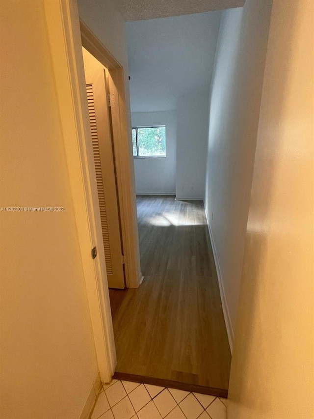 hall featuring light tile flooring