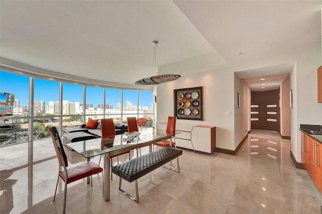 dining area featuring light tile floors and floor to ceiling windows