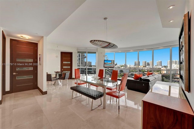 living room with floor to ceiling windows and light tile flooring