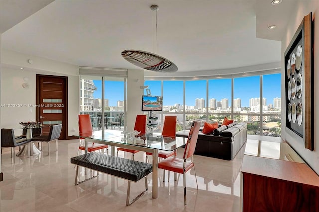 tiled dining area featuring plenty of natural light and expansive windows