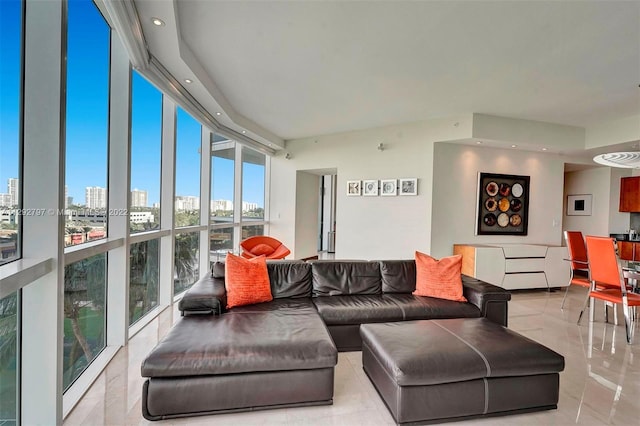 tiled living room with a wall of windows