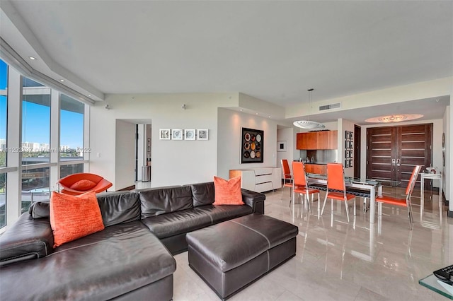 tiled living room featuring a wall of windows